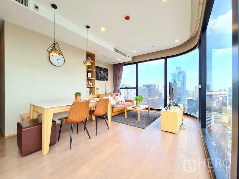 Condominium for rent in Bang Rak, Bangkok - Spacious open living area with hardwood floors and expansive windows.