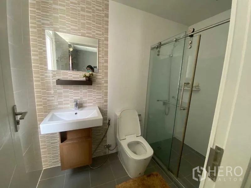 Home Office for rent or sale in Bang Phli, Samut Prakan - Bathroom with glass-enclosed shower, vanity sink and toilet.