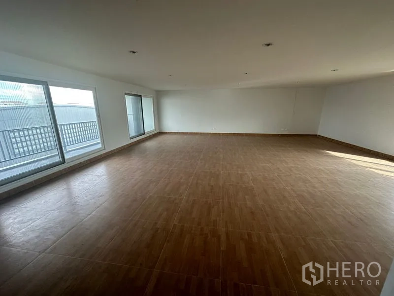 Home Office for rent in Bang Phli, Samut Prakan - Upper floor with wood-look tiles and large windows to balcony.