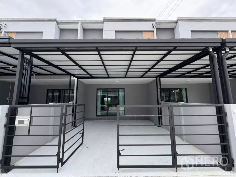 Townhouse for rent in Bang Phli, Samut Prakan - Modern gray townhouse facade with covered two-car carport and metal gate