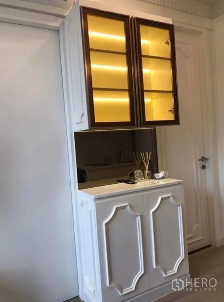Condominium for rent in Watthana, Bangkok - Hallway view into bright living area with tall curtains and wood floors