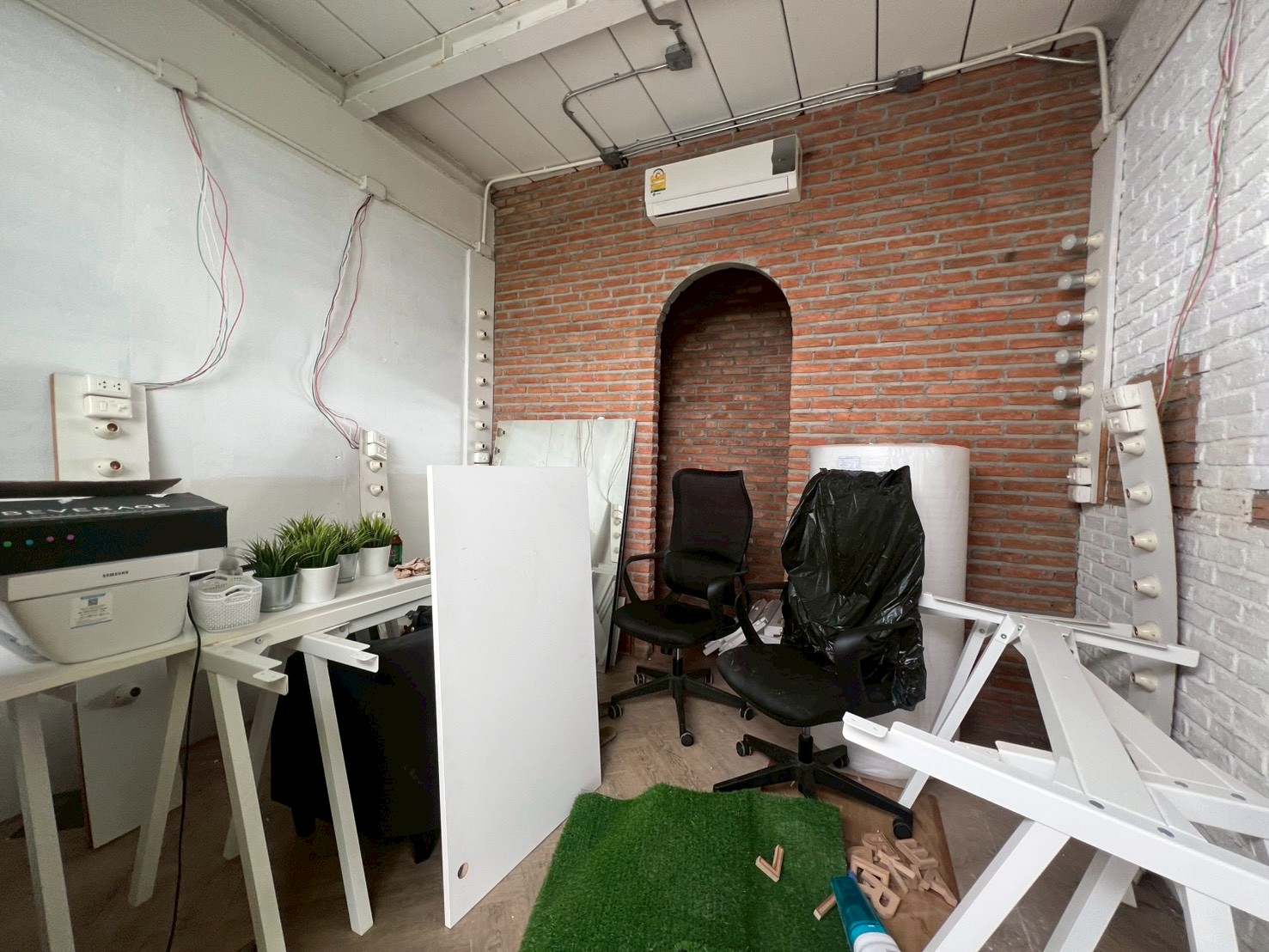 Retail Space for rent in Watthana, Bangkok - Compact office corner with exposed brick archway, air-conditioning and wiring ready for fit-out.