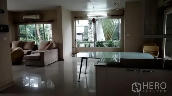 Detached House for rent in Lat Krabang, Bangkok - Open living and dining space with garden views through wide windows and sliding doors.