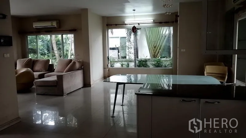 Detached House for rent in Lat Krabang, Bangkok - Open living and dining space with garden views through wide windows and sliding doors.
