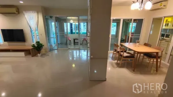 Detached House for rent in Bang Phli, Samut Prakan - Open-plan living and dining area with a glass-enclosed sunroom.