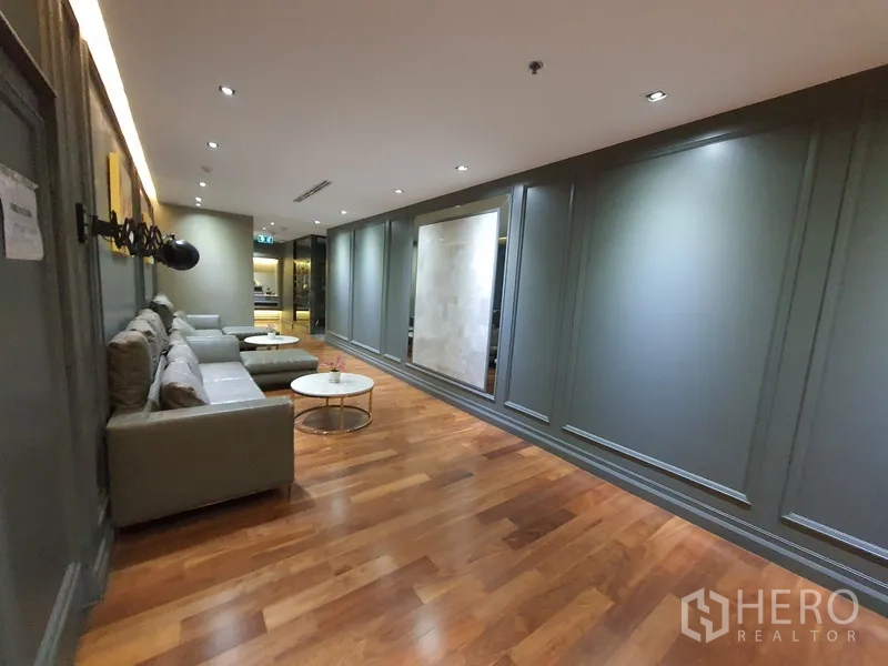 Office Space for rent in Khlong Toei, Bangkok - Another view of lounge seating along paneled wall and wood flooring.