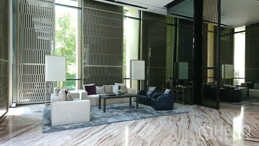 Condominium for rent in Watthana, Bangkok - Grand double-height condo lobby with marble floors, floor-to-ceiling windows, and plush lounge seating.
