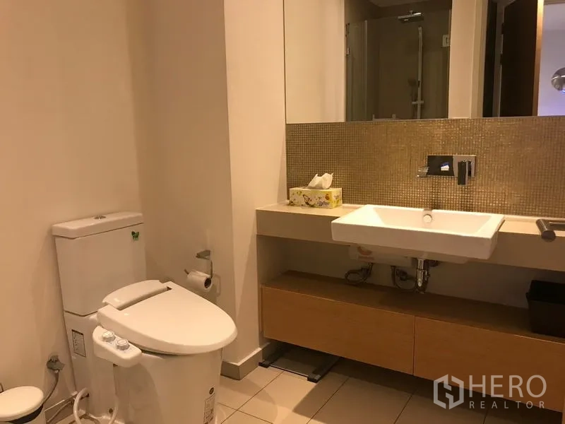 公寓 出租在Watthana, Bangkok - 现代浴室，悬空洗手台、大镜子与坐便器