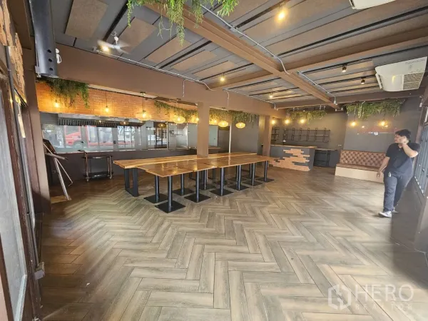 Retail Space for rent in Watthana, Bangkok - Open-plan retail interior with brick feature wall, greenery accents, bench seating and wide floor space.