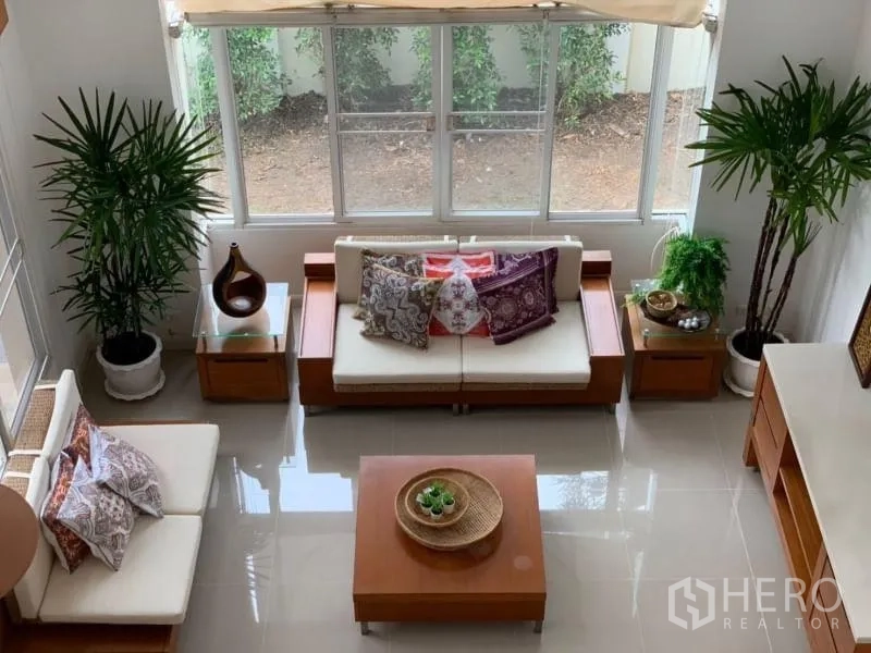 Detached House for rent in Lat Krabang, Bangkok - Living room viewed from above showing sofa set and big windows.