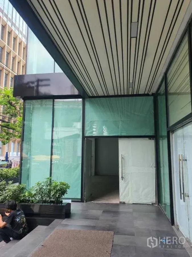 Retail Space for rent in Bang Rak, Bangkok - Retail frontage at the tower podium with tall glass panels and canopy.