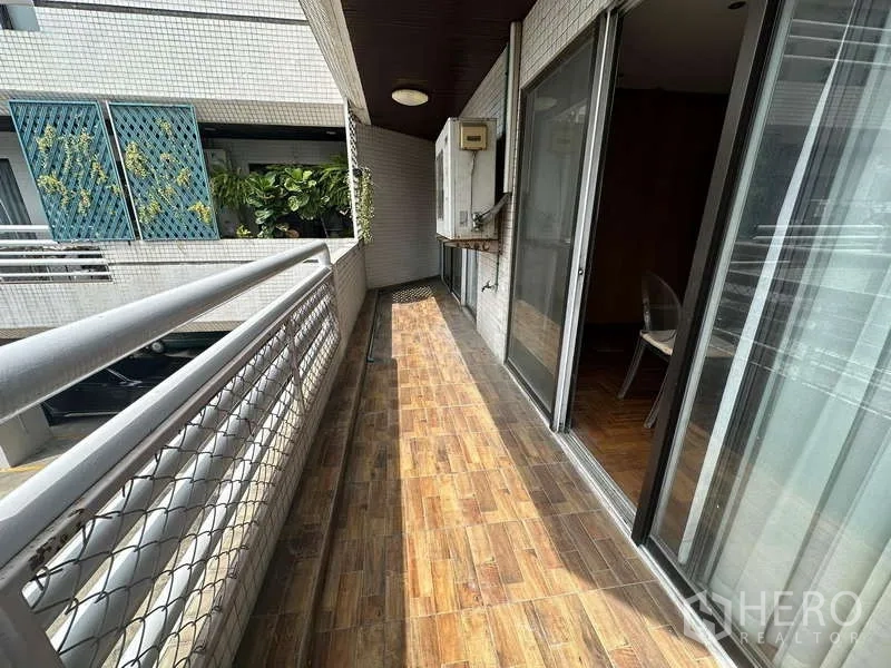 公寓 出租在Watthana, Bangkok - 狭长瓷砖阳台，带推拉门与安全栏杆。