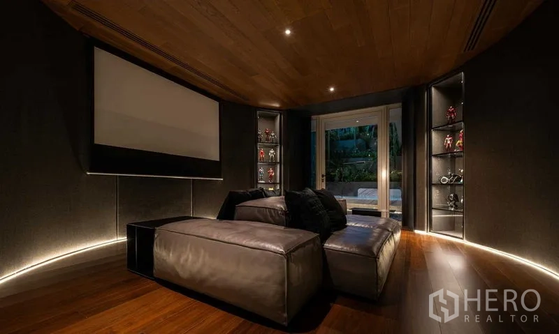 Detached House for sale in Saphan Sung, Bangkok - Cozy home theater with projector screen, dark walls and sectional seating.