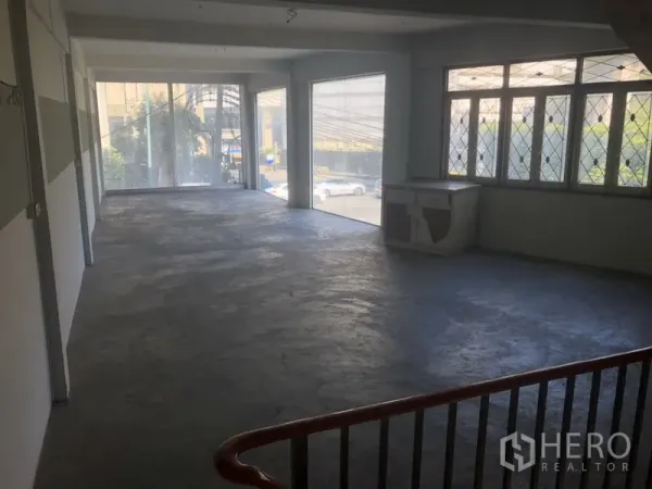Retail Space for rent in Khlong Toei, Bangkok - Spacious upper level with large windows facing the street and polished concrete floor.
