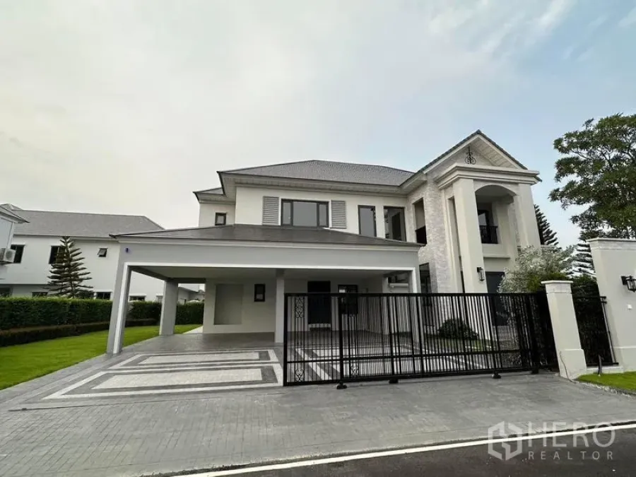 Detached House for sale in Lat Krabang, Bangkok - Front elevation of the detached house with gated driveway and wide covered parking.