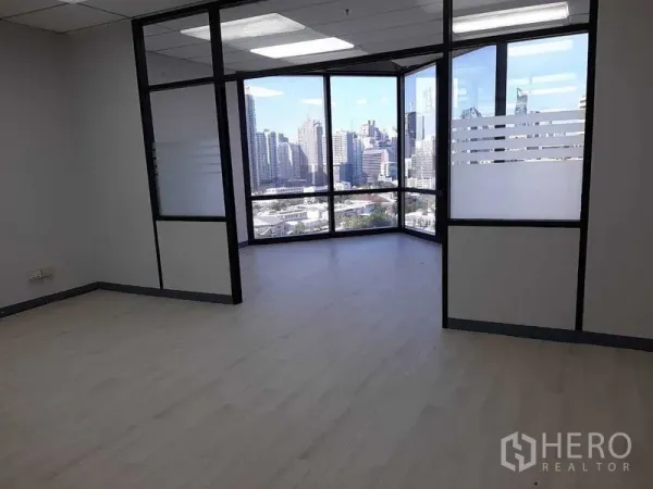 Office Space for rent in Khlong Toei, Bangkok - Corner office with floor-to-ceiling windows and Bangkok skyline view.