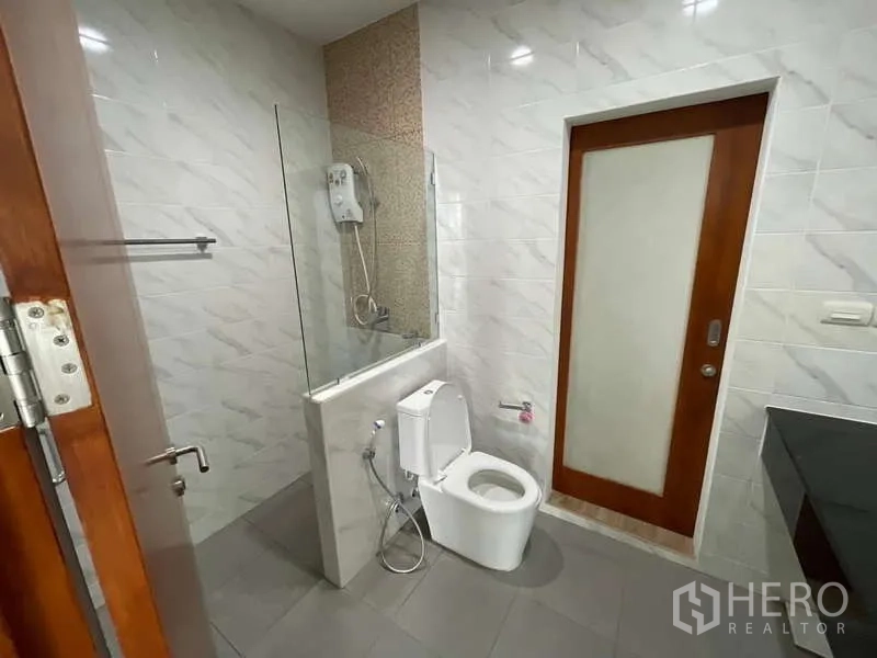 带办公室的家 出租或出售在Wang Thonglang, Bangkok - 浴室配玻璃隔断淋浴、坐便器与壁挂式热水器