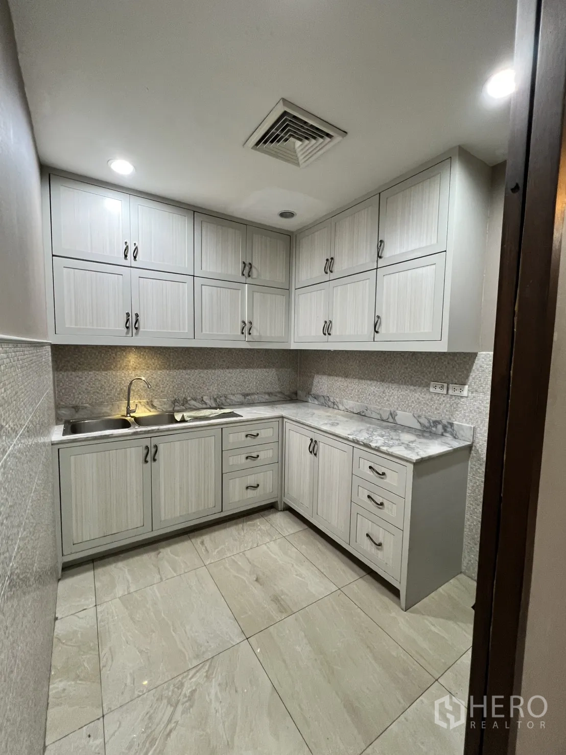 Office Space for rent in Watthana, Bangkok - Pantry with upper and lower cabinets, sink, and marble-look counters.