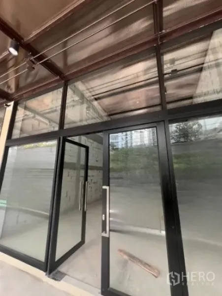 Retail Space for rent - Retail unit with floor-to-ceiling glass storefront and black metal frames, shell interior.