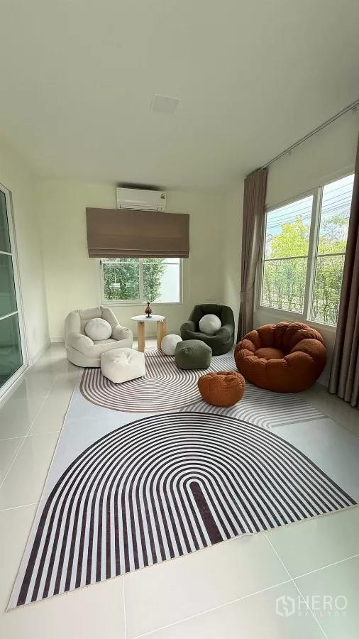 Detached House for rent in Bang Phli, Samut Prakan - Bright multi-purpose room with lounge chairs on a patterned rug and garden views.