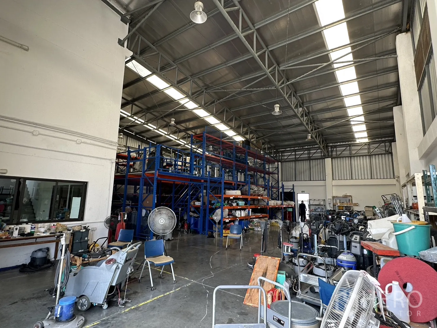 Factory for rent or sale in Pathum Thani - High-bay warehouse aisle with racking systems and polished concrete floor.