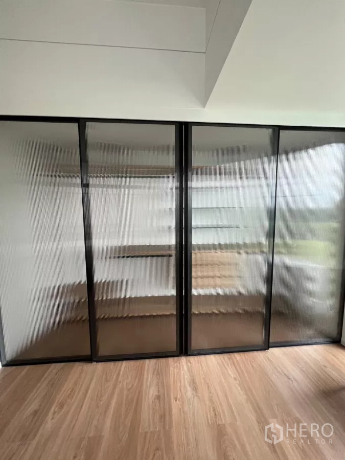 Detached House for rent in Saphan Sung, Bangkok - Ribbed glass sliding wardrobe doors creating a semi-transparent closet.