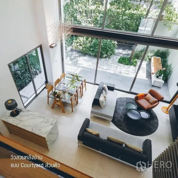Townhouse for rent - Double-height living and dining area viewed from above facing the courtyard