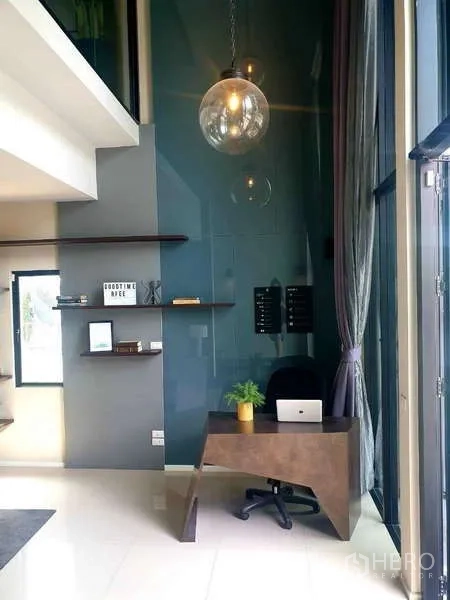 Home Office for rent in Bang Phli, Samut Prakan - Double-height workspace with floor-to-ceiling glass, a pendant light and a compact reception desk.