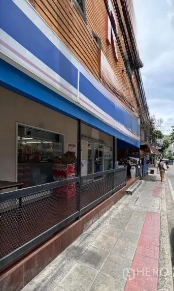 Retail Space for rent in Watthana, Bangkok - Sidewalk view of the retail unit with railing, canopy and wide glass windows suitable for signage and display.