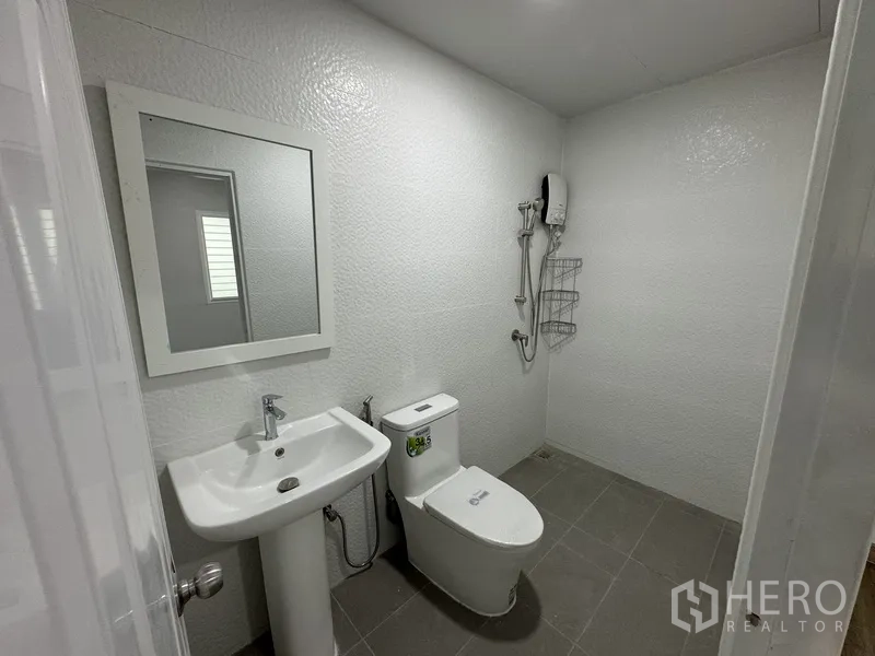 Townhouse for sale in Bueng Kum, Bangkok - Third bathroom with pedestal sink, toilet and shower zone.