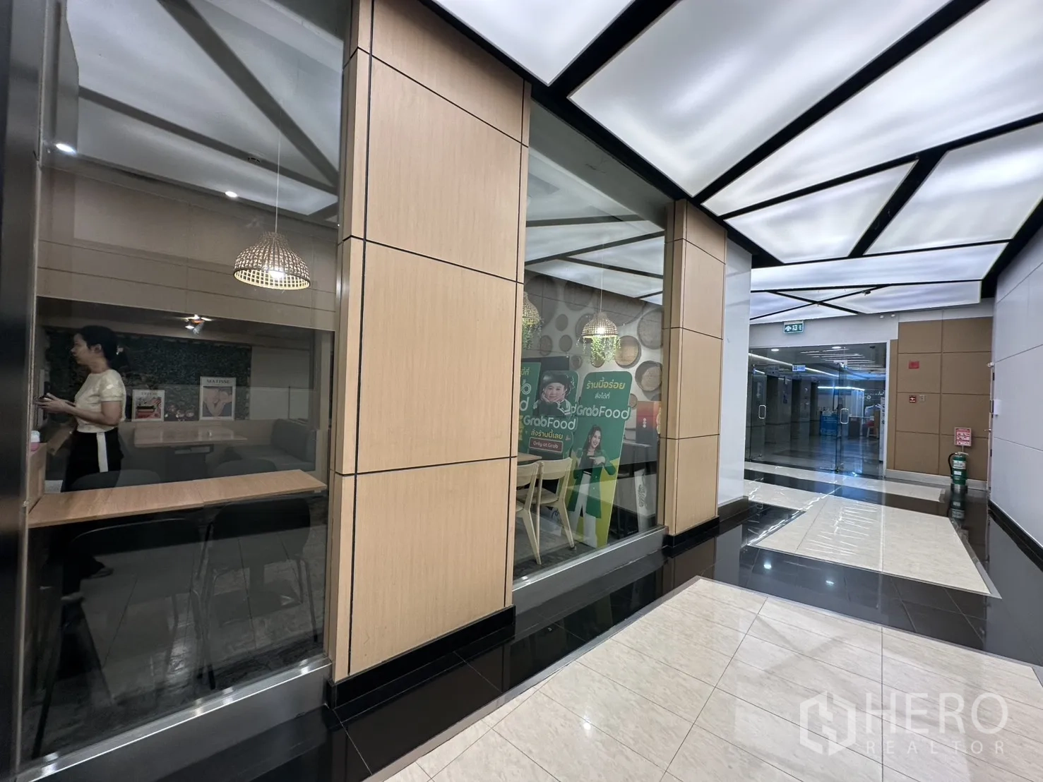 Retail Space for rent in Watthana, Bangkok - Exterior corridor view of the unit’s glass facade inside the building.