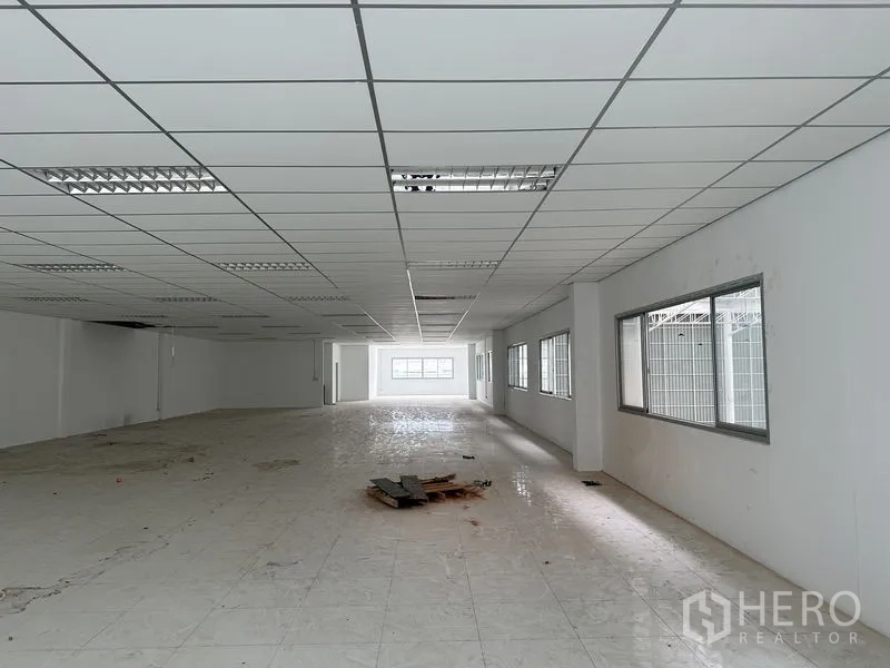 Factory for rent in Pathum Thani - Bright mezzanine office space with rows of windows overlooking the warehouse.