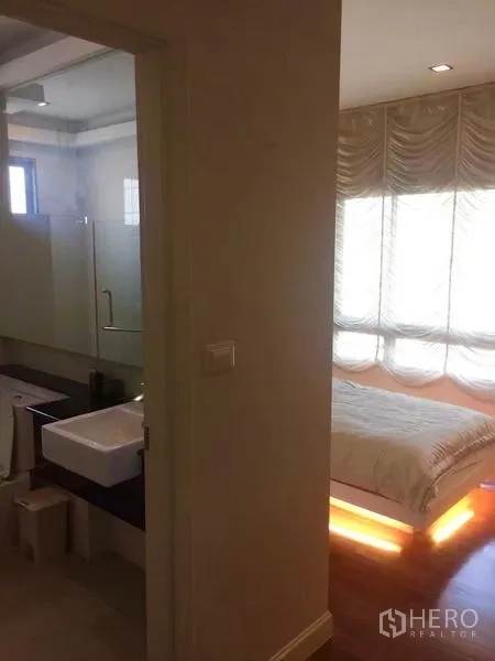 Detached House for sale in Lat Krabang, Bangkok - Ensuite bathroom with glass shower and vanity next to the bedroom entrance.