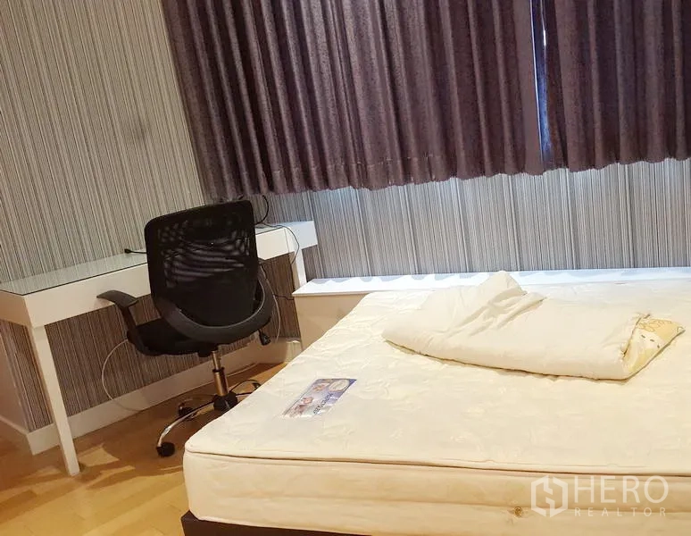 公寓 出租在Khlong Toei, Bangkok - 次卧带书桌与转椅，遮光窗帘营造安静空间。