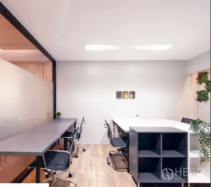 Office Space for rent in Bang Rak, Bangkok - Private office room with shared desks, storage cube shelving, and a glass partition.