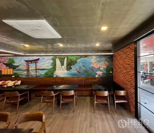Shophouse for rent in Watthana, Bangkok - Main dining room with long banquette seating and mural, opening to the street.