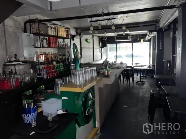 Shophouse for rent or sale in Watthana, Bangkok - Ground-floor interior fitted as a bar with long counter, shelving and front glazing.