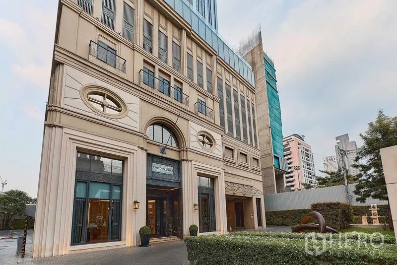 公寓 出售在Bang Rak, Bangkok - 公寓入口立面典雅，拱形门廊与景观绿化。