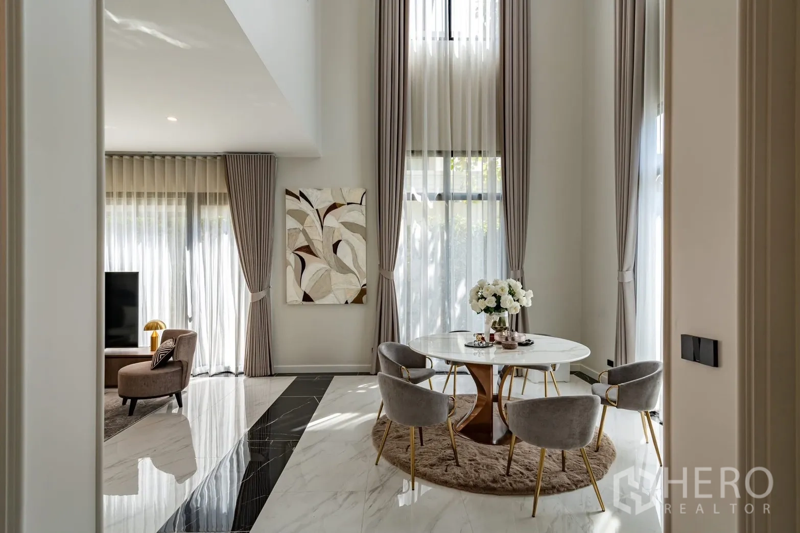 Detached House for rent or sale in Saphan Sung, Bangkok - Sunlit dining nook with round table and full-height curtains.