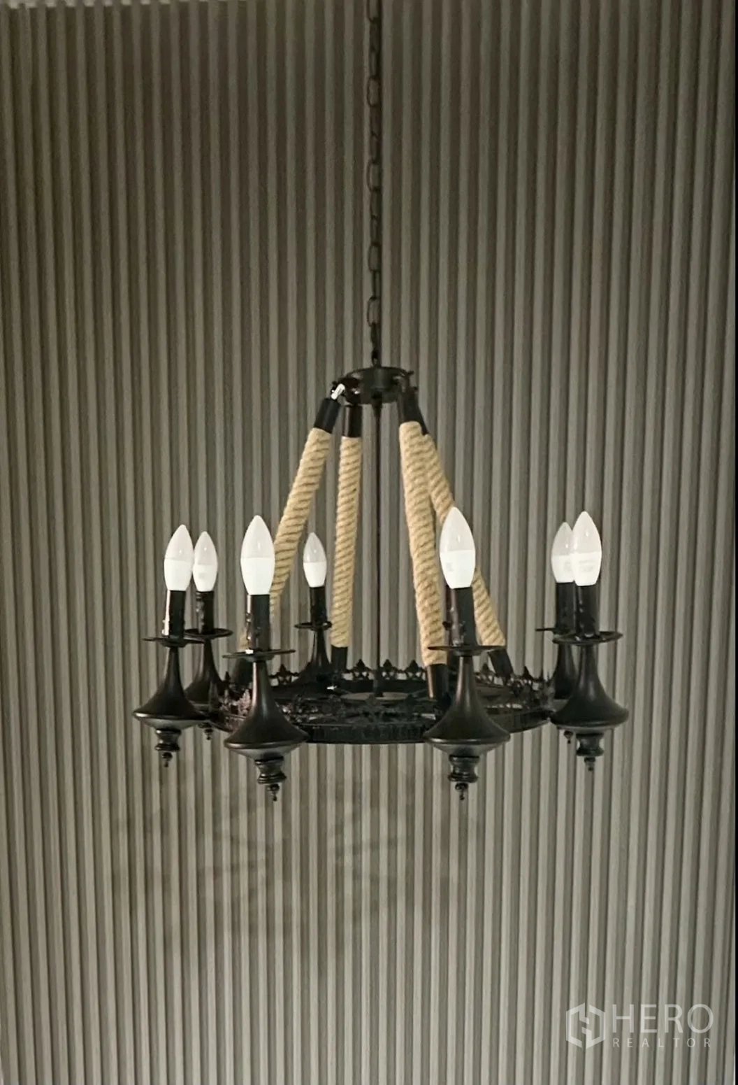 Home Office for rent in Khlong Toei, Bangkok - Black chandelier with rope accents against ribbed wall panels.