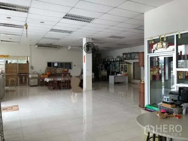 Factory for rent or sale in Lam Luk Ka, Pathum Thani - Spacious tiled lobby and office area with drop ceiling, tables and shelving.