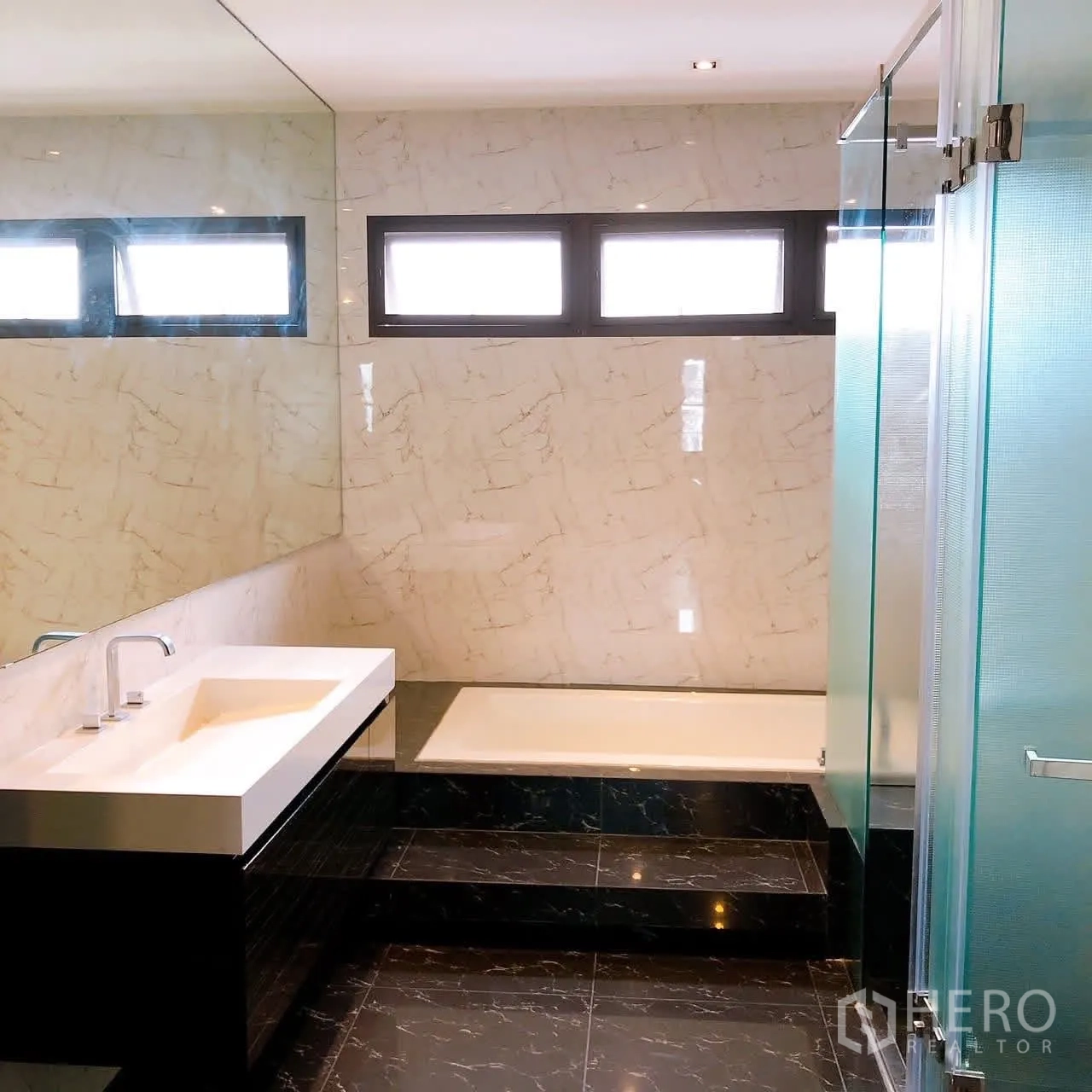 Townhouse for rent or sale in Lat Phrao, Bangkok - Bathroom with bathtub, wide vanity and marble-look tiles.