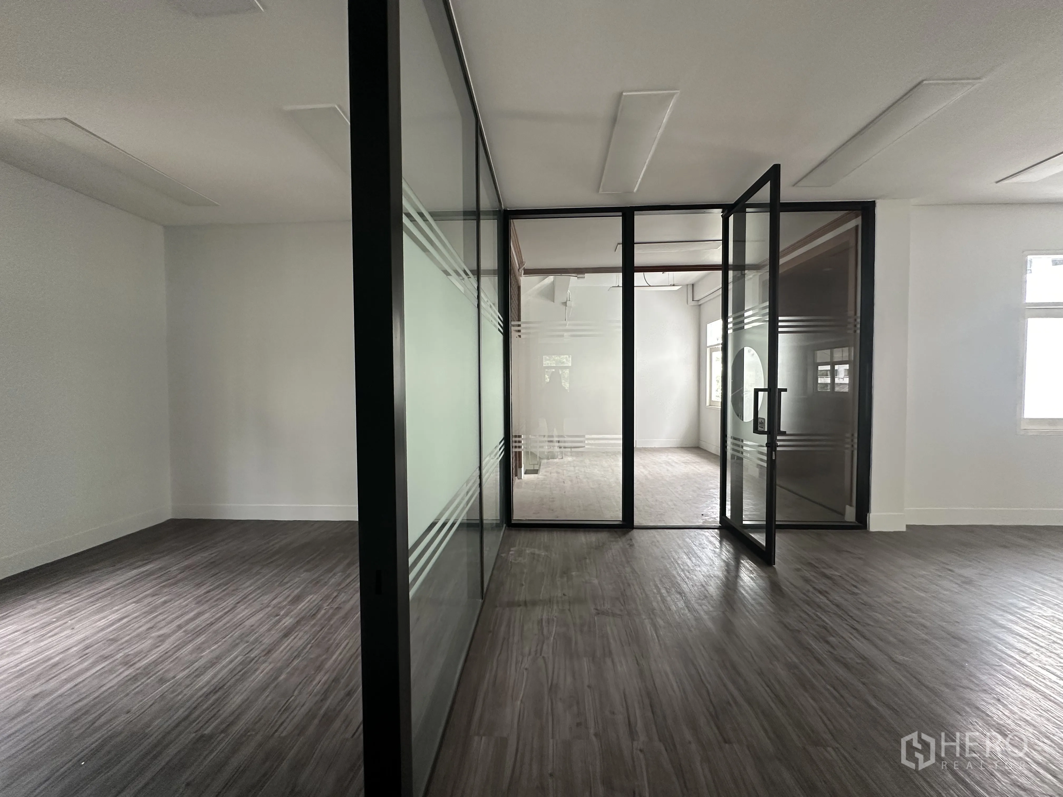 Retail Space for rent in Bang Rak, Bangkok - Close view of framed glass partition and door dividing the retail area.