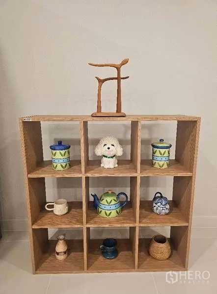 Detached House for rent in Bang Phli, Samut Prakan - Open cube wooden shelf displaying ceramic pots, cups and decor pieces.