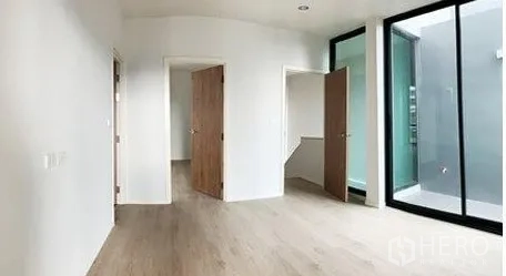 Home Office for rent in Don Mueang, Bangkok - Open room with light wood floors, white walls and large sliding glass.