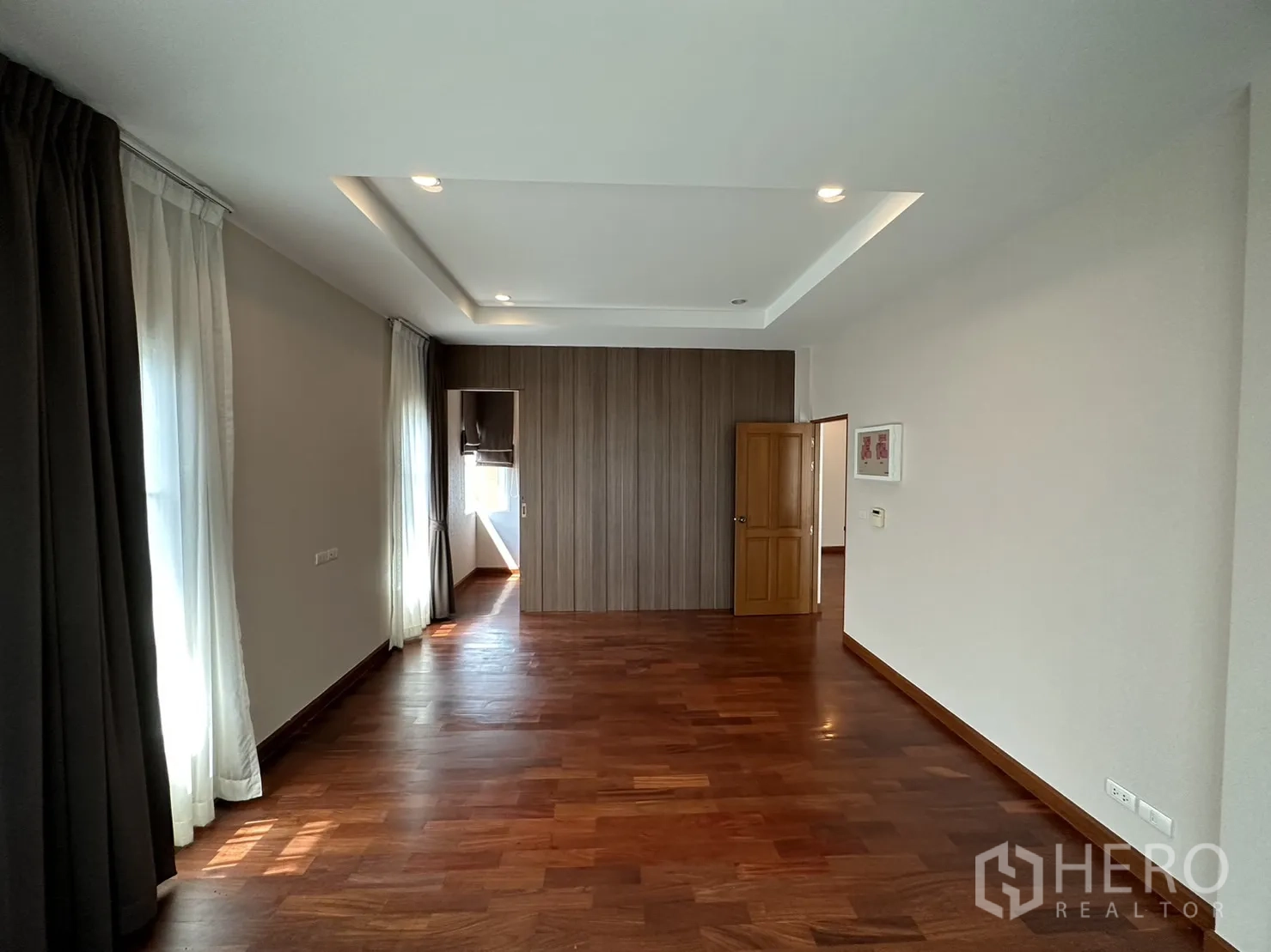 独立式住宅 出租或出售在Pak Kret, Nonthaburi - 采光充足的卧室，托盘天花与多扇窗，木地板。