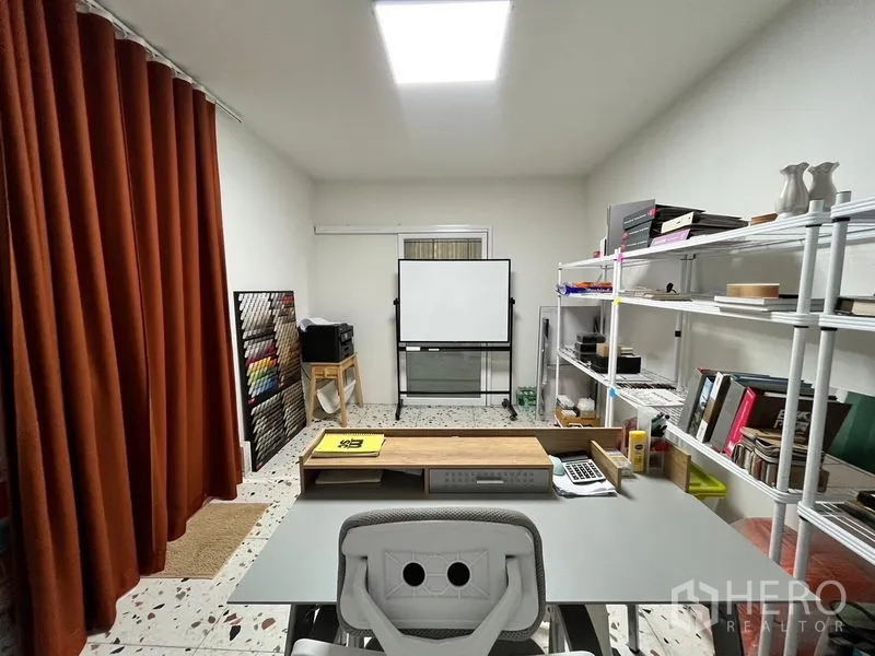 Warehouse for rent in Khan Na Yao, Bangkok - Compact office room with desk, shelving, and whiteboard under bright lighting.