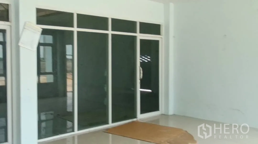 Warehouse for rent in Bang Len, Nakhon Pathom - Ground-floor glass-partitioned office space with sliding door.