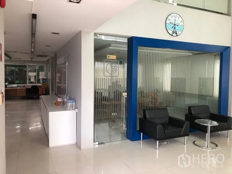 Factory for rent or sale in Lat Lum Kaeo, Pathum Thani - Modern office lobby with glass meeting room and black lounge chairs.