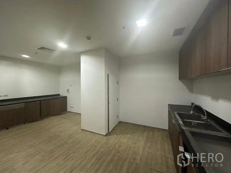 Office Space for rent in Khlong Toei, Bangkok - Pantry with built-in cabinets, sink, and ample counter space.